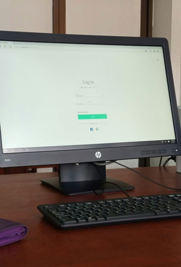 black computer monitor turned on beside black computer keyboard